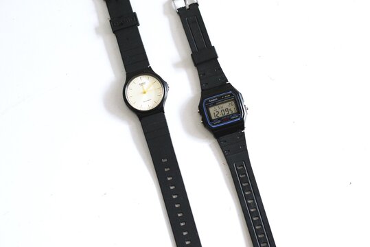 Analog and digital casio watches side by side on white background