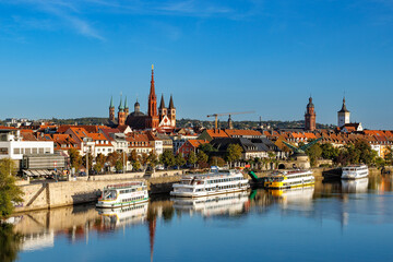 Fototapeta premium Würzburg cityscape with river and historic churches on a clear autumn day.