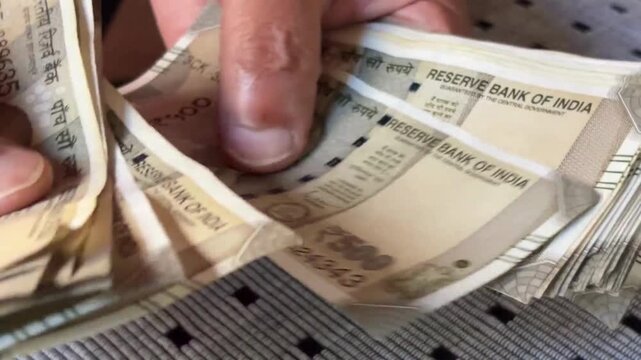 Counting Indian 500 rupees notes