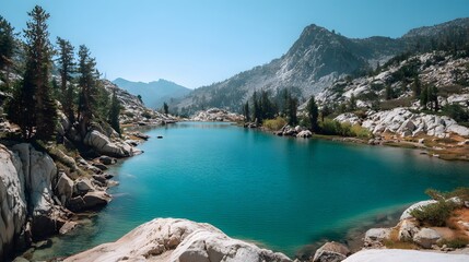 High alpine lake shimmers with brilliant turquoise water nestled among granite peaks and evergreen trees