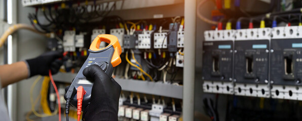 Electrical technician hand checking electricity circuit breaker main power on switchboard cabinet...