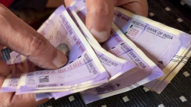 Counting 100 indian rupee notes