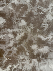 Close up of grey silver washed and grunge dirt in random pattern. In bright metallic gold color. Suitable for upholstery, carpet, fabric, graphic background, and wallpaper. Seamless background texture