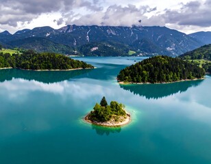 Aerial view of a serene, turquoise lake dotted with islands, framed by mountains