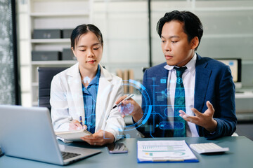 Two business experts analyze data and AI innovation using futuristic holographic technology in a modern corporate office