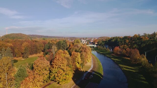 Colourful Komensky park golden autumn trees on River Ostravice AERIAL