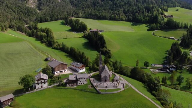 Aerial View on Church in Santa Maddalena, Italy. Green Colorful Landscape in Land Near Alps, Dolomites. Drone Shot