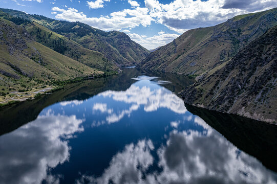 Drone photo of calm surface of Snake river, Hells Cayon. Clouds reflection in blue water