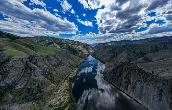 Drone photo of calm surface of Snake river, Hells Cayon. Clouds reflection in blue water