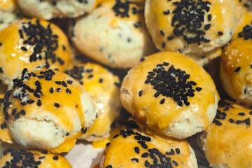 Freshly baked sweet rolls with sesame seeds for sale