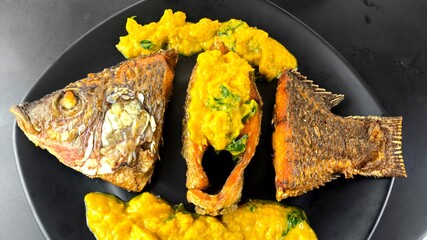 Deep-fried tilapia fish with pumpkin sauce, indoor Chiangmai Thailand.