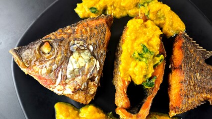 Deep-fried tilapia fish with pumpkin sauce, indoor Chiangmai Thailand.