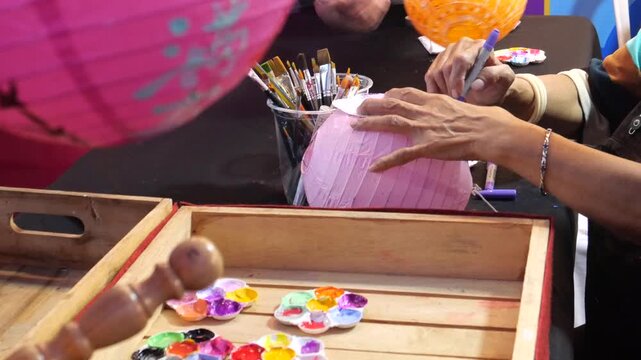 Painting Akash Kandil or traditional decorative lantern during Diwali Festival