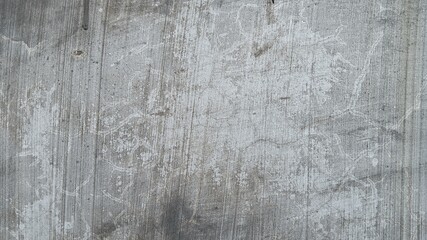 Close-up of dark, heavily scratched concrete texture with dramatic bright cracks for an intense grunge effect.