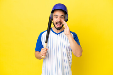 Young caucasian man playing baseball isolated on yellow background shouting with mouth wide open