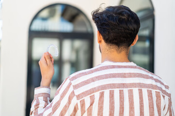 Handsome Arab man holding invisible braces at outdoors in back position