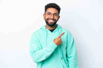Young Brazilian man isolated on white background pointing to the side to present a product