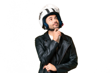 Young caucasian man with a motorcycle helmet over isolated chroma key background and looking up
