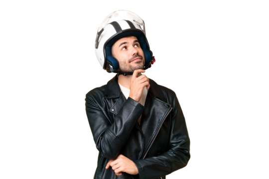 Young caucasian man with a motorcycle helmet over isolated chroma key background and looking up