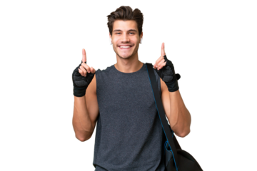 Young sport caucasian man with sport bag over over isolated background pointing up a great idea