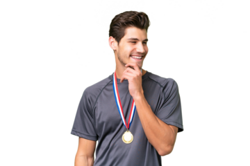 Young caucasian man with medals over isolated background looking to the side