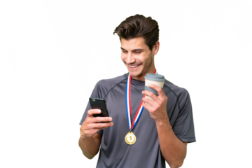 Young caucasian man with medals over isolated background holding coffee to take away and a mobile