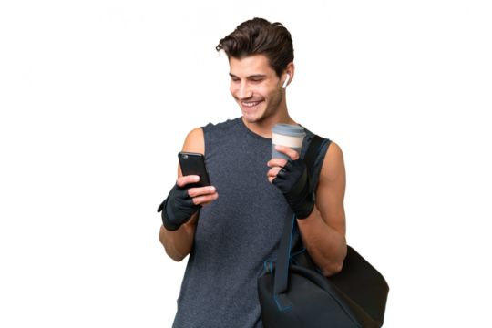 Young sport caucasian man with sport bag over over isolated background holding coffee to take away and a mobile