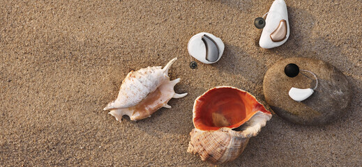Hearing impaired human uses hearing aids while relaxing on the beach. Lifestyle of people with hearing problems