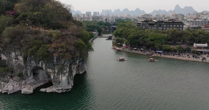 Aerial view of Elephant Trunk Hill and bamboo rafts moving along the Li River.