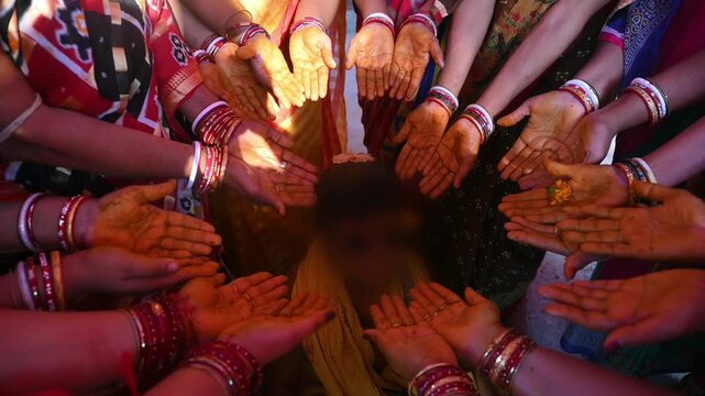 Hands of Women holding turmeric paste during indian wedding ceremony, Face was blurred, haldi ceremony in an Indian wedding.