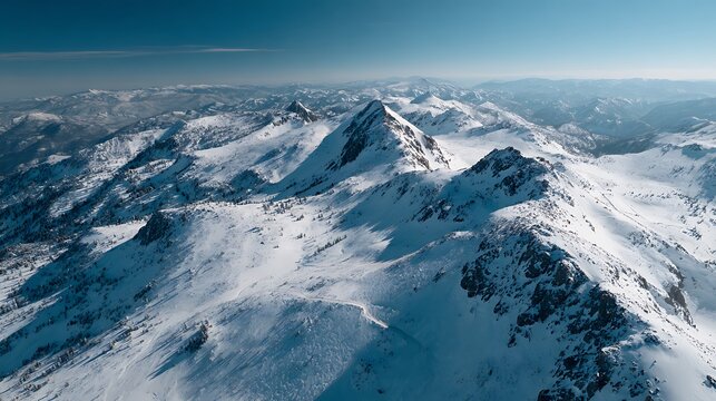 Snowcapped Mountain Peaks Underneath a Clear Blue Sky Panorama View