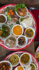 Colorful Array of Traditional Dishes Served on Plates in Vibrant Restaurant Setting
