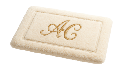 Custom-embroidered bath mat for a master suite, featuring personalized initials.