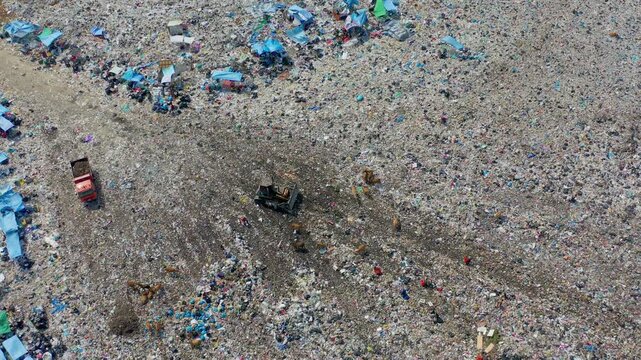 Aerial 4K: Waste Pickers, Bulldozer, and Garbage Truck Working at Massive Landfill