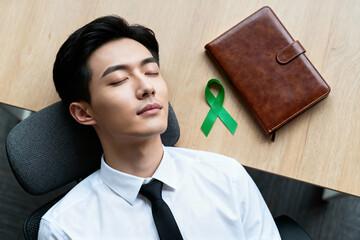 Mental Health Awareness a Man Sleeping in Office Chair