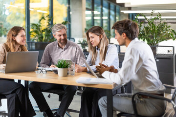 Group of happy progressive business people working on startup together at creative office