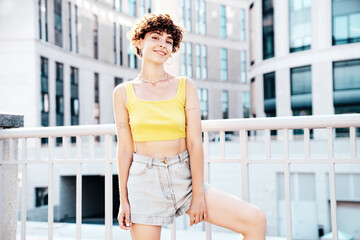 Young beautiful smiling hipster woman in trendy summer clothes. Carefree woman with curls...