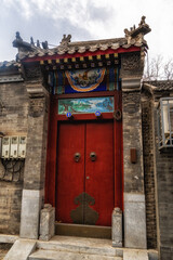 Fototapeta premium Traditional old style richly decorated house in street in Xi Cheng Hutong District