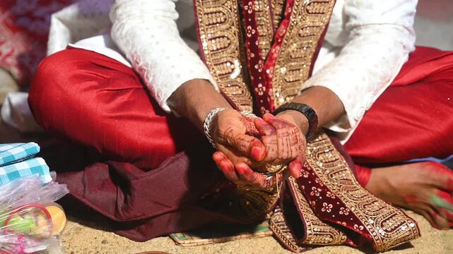Hands of the bride and groom in wedding Ceremony. Hindu wedding ritual. Odia Wedding. Hindu Wedding Ceremony with Burning Fire and Offering Ritual with People and Golden Details.