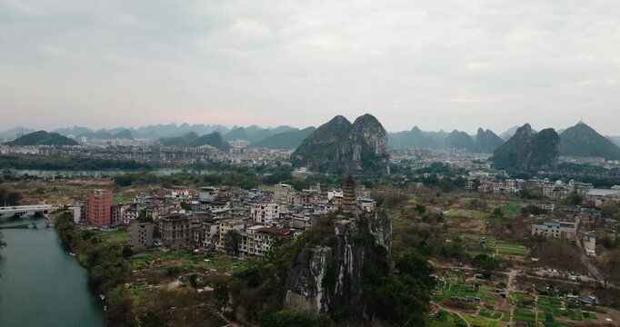 Aerial scenery highlights a pagoda on a steep karst hill above Guilin&rsquo;s outskirts.