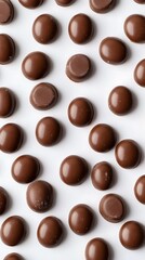 Fototapeta premium Milk Chocolate Candies Seamless, Overhead Pattern of Domed Treats on a White Surface