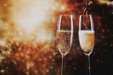 toasting with champagne glasses against holiday lights