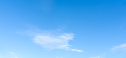 Low angle view and full frame of beautiful light blue sky with strange shape of fluffy thin white clouds in the afternoon on sunny day used as natural background texture in decorative art work