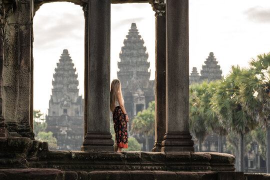 Woman traveling angkor wat admiring ancient temple architecture