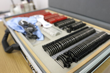 A set of ophthalmic trial lenses and trial frames used for vision testing and refraction assessment.