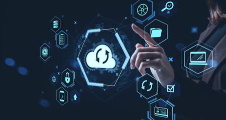 Cloud backup service concept with hand interacting with holographic digital interface icons on dark background representing storage and data management.