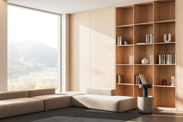 Modern minimalist interior with light wood bookshelf and beige modular sofa in sunlit living room with mountain view window. 3D Rendering