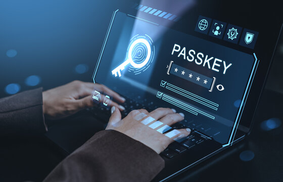 Cybersecurity login with passkey on futuristic interface while typing on laptop in dark environment with glowing blue light effects concept..