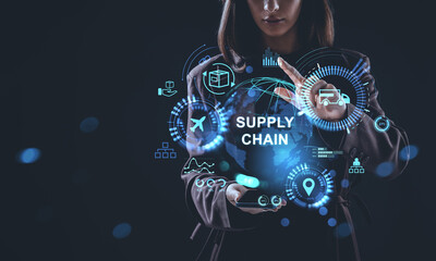 Woman interacting with futuristic hologram interface showing global supply chain concept and logistics data visualization on dark background.