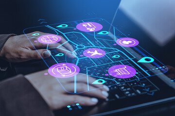 Digital supply chain management interface with logistics icons over hands typing on keyboard in futuristic technology concept on dark background.